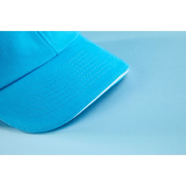 A blue 6 Panel Raver Sandwich Cap with a curved brim and visible stitching, featuring a logo on the front.