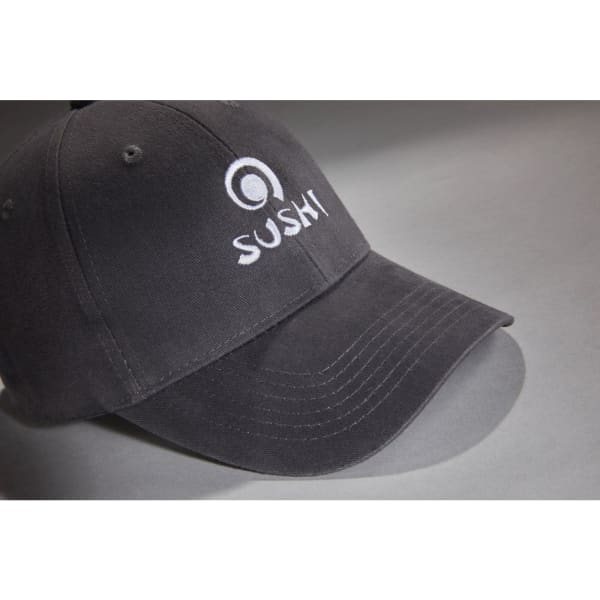 A black brushed 6 panel cap featuring an embroidered logo. The cap has a curved brim and adjustable back.