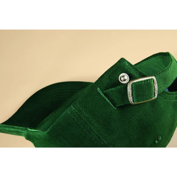 A green 6 Panel Raver Cap featuring a buckle closure and a structured design. Includes a logo on the side.