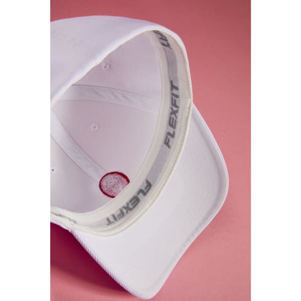 A white High Performance Flexfit® cap displaying its inner lining and structured brim, featuring a logo.