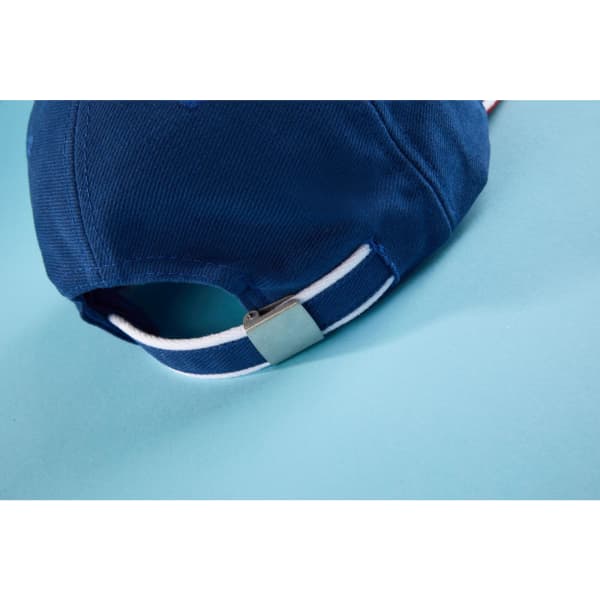 A navy blue 6 panel double sandwich cap featuring a metal adjustable strap and a logo on the back.