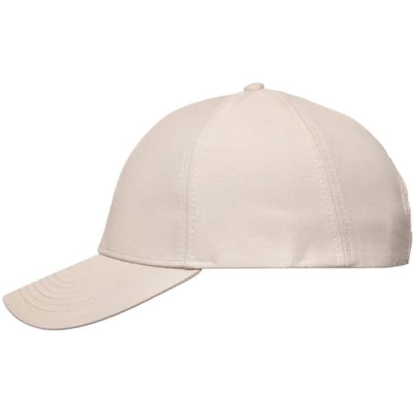 A cream-coloured six-panel cap with a curved peak and stitched detailing, featuring a logo on the front.