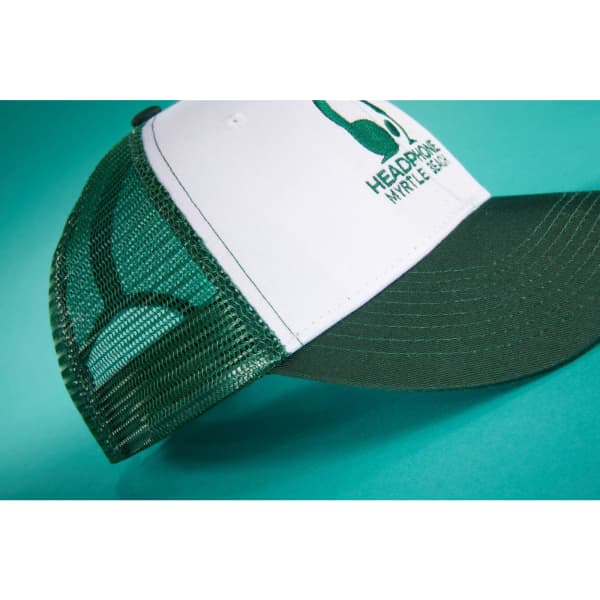 A green and white 6 panel mesh cap with a curved brim and a logo on the front.