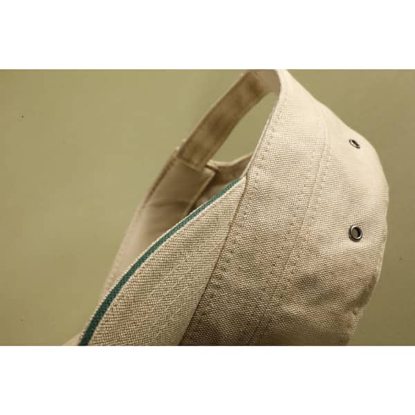 A beige military-style cap featuring a logo, with a contrasting coloured inner lining.