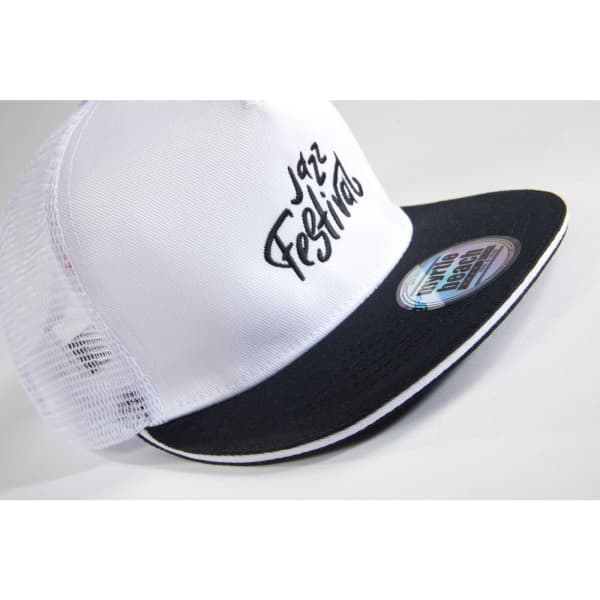 A white and black trucker cap featuring a mesh back and a curved brim, with a logo on the front.