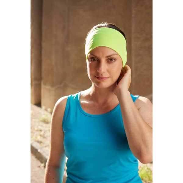 A running headband in bright green, worn by a person in a blue tank top, set against a neutral background.