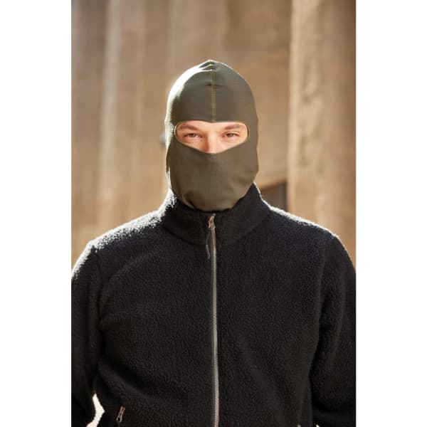 A green balaclava worn by a person in a black fleece jacket. The background is blurred, highlighting the product.