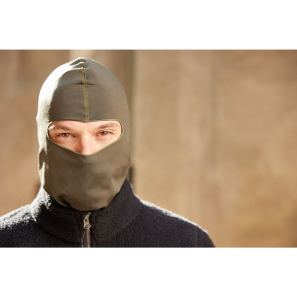 A person wearing an olive green balaclava with a zippered black fleece jacket, looking directly at the camera.