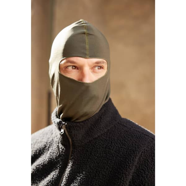 A green balaclava worn by a person, featuring a fitted design and a partial face cover.