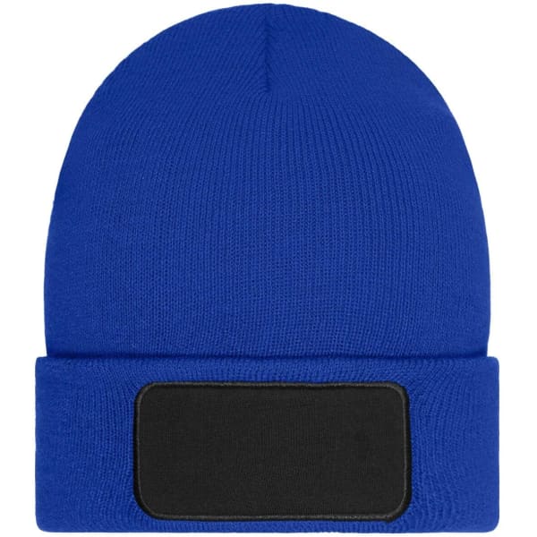 A blue beanie with a fold-up cuff and a blank black patch for customisation.