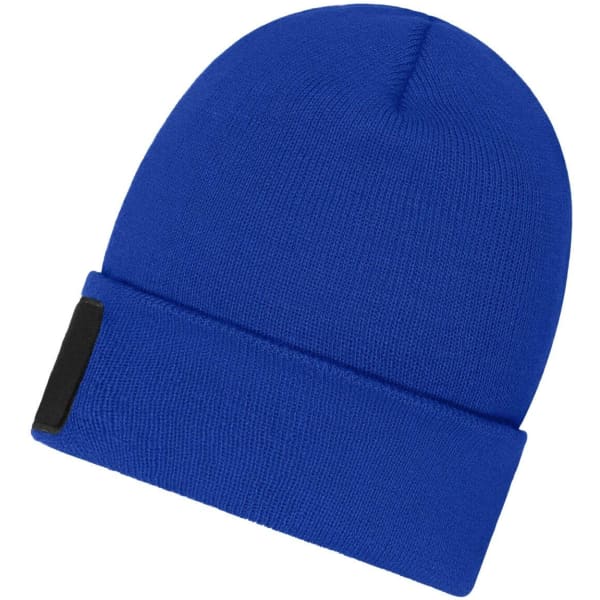 A blue beanie with a patch, featuring a snug fit and a folded cuff design.