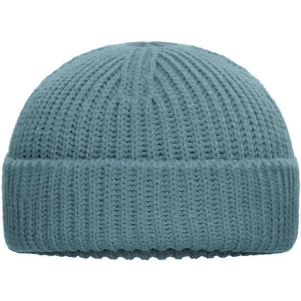 A blue knitted beanie with a ribbed texture and a folded cuff. It features a logo on the side.