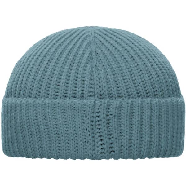 A blue knitted beanie with a ribbed texture, featuring a folded cuff and a logo on the side.