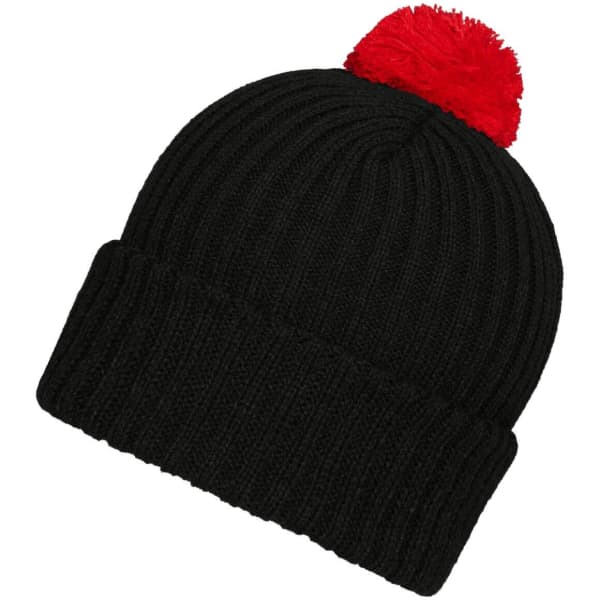 A black knitted beanie with a red pompon on top and a ribbed texture. It features a logo on the side.
