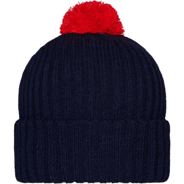 A navy knitted beanie with a bright red pompon on top. It features a ribbed design and a rolled cuff.