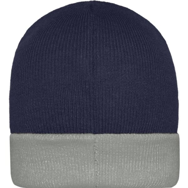 A knitted beanie in navy blue with a grey cuff, featuring a logo on the side.