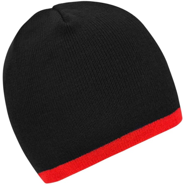 A beanie in black with a contrasting red edge. The hat has a ribbed texture and a logo on it.