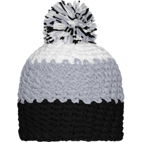 A beanie with a pompon, featuring grey, white, and black colours. The beanie has a textured pattern and a round pompon on top.