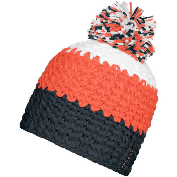 A knitted beanie in orange, white, and navy blue featuring a fluffy pompon on top and a logo tag.