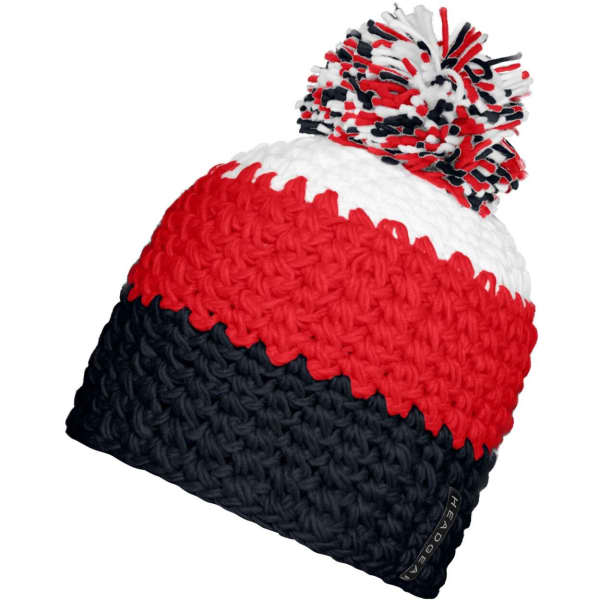 A beanie in red, white, and navy with a pompon on top, featuring a brand logo.