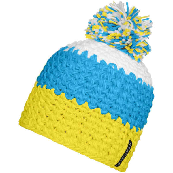 A beanie with a pompon, featuring blue, white, and yellow crochet patterns. It has a logo on the side.
