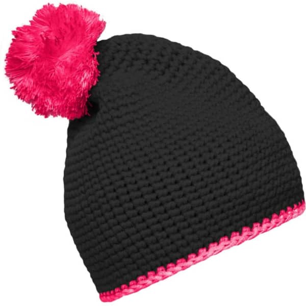 A black crochet pompon hat with a bright pink pompom and contrast stripe at the base. Features a logo.
