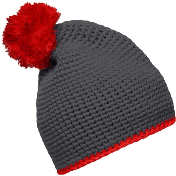 A grey knitted hat with a red pompom and contrast red stripe along the base. Includes a logo.
