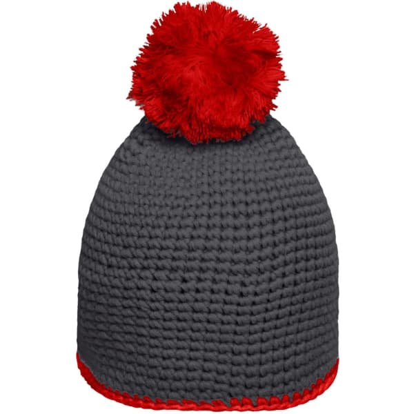 A grey knitted hat with a red pompom and contrast red stripe at the base, featuring a logo.