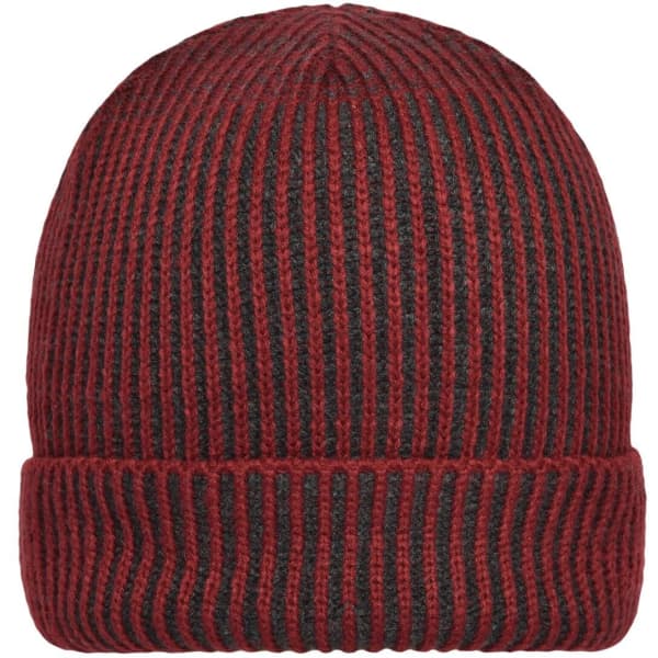 A ribbed beanie in dark red and black with a folded cuff. It has a logo on the side.