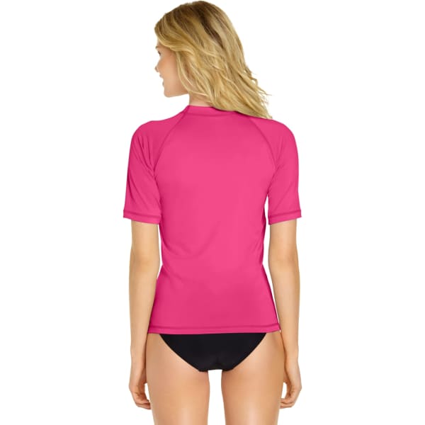 A pink short sleeve rash guard with a snug fit, featuring a back view and near the waistline, paired with black swim bottoms.
