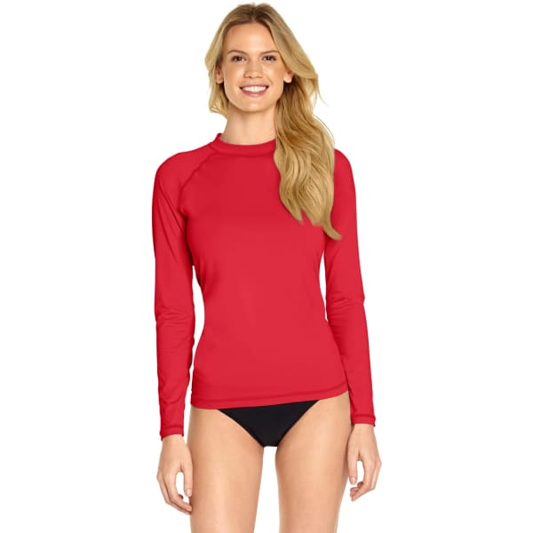 A red long sleeve rash guard with UPF 50+ protection. The model features a casual, smiling pose.