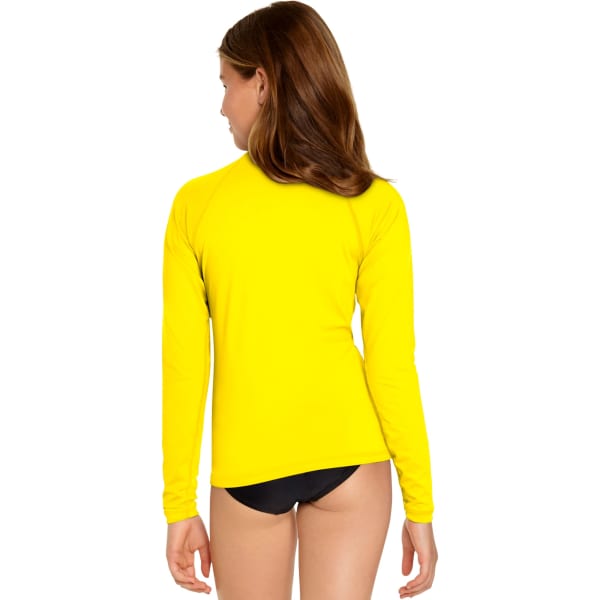 A young girl wearing a bright yellow long sleeve rash guard, with a black bottom, featuring a logo.