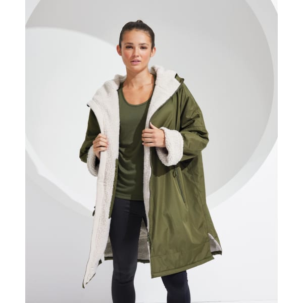 An olive green waterproof changing robe with a light fleece interior and a hood, featuring a logo on the sleeve.