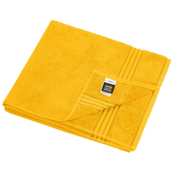 A folded yellow sauna sheet with a textured surface, featuring a tag on one corner and a simple design.