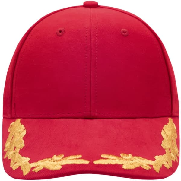 A red 6 panel cap featuring a decorative gold design on the brim and a logo on the front.