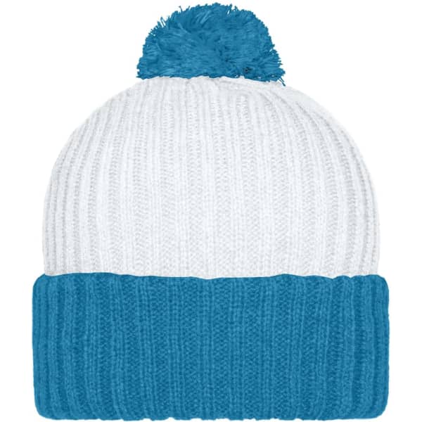 A knitted cap in white and teal with a fluffy pompon on top and a ribbed band at the base.