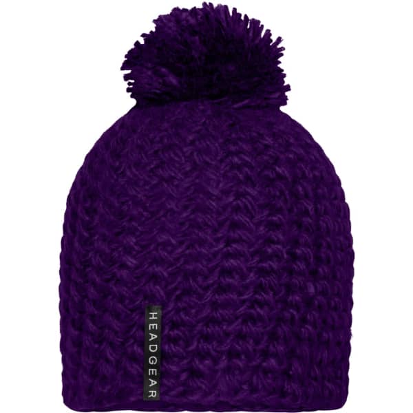 A purple crocheted cap with a pompon on top, featuring a branding label on the side.