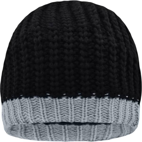 A knitted hat in black and grey with a ribbed design, featuring a logo on the side.