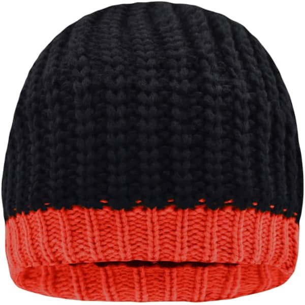 A knitted hat featuring a black upper section and a bright orange lower section, with a logo on it.