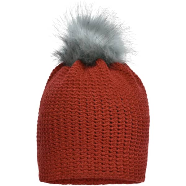 A fine crocheted beanie in rust red featuring a fluffy grey pompom on top. It has a textured design and a logo.