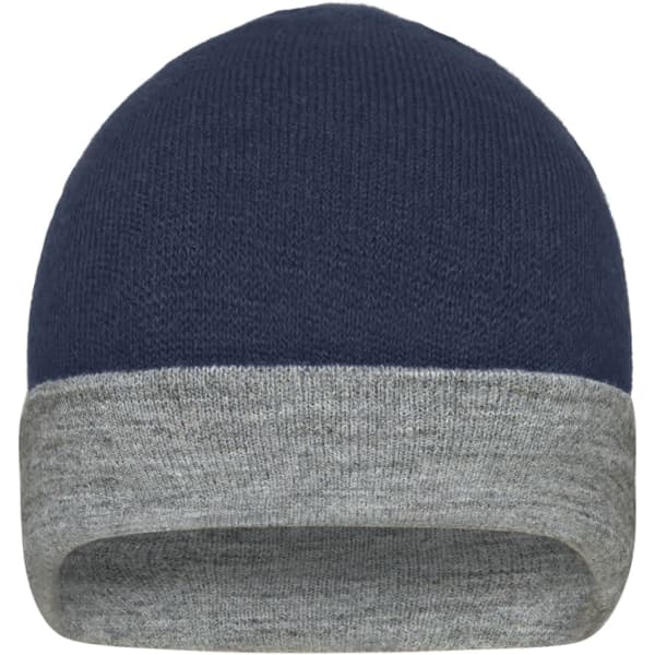 A reversible beanie featuring a navy blue exterior and a grey cuff, with a logo on one side.