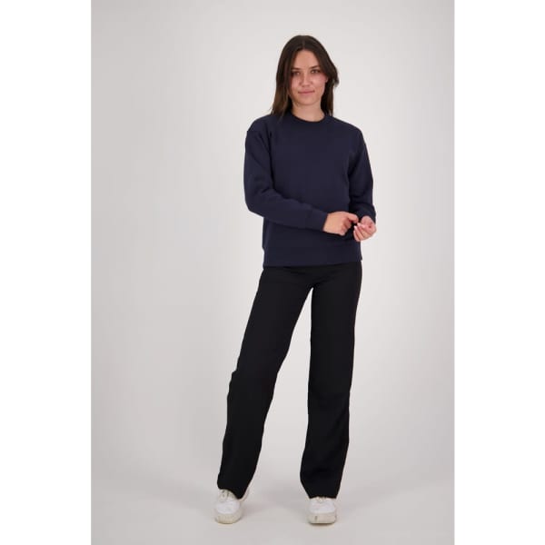 A woman stands confidently in a navy crew neck sweatshirt and black pants, with a logo visible on the sweatshirt.
