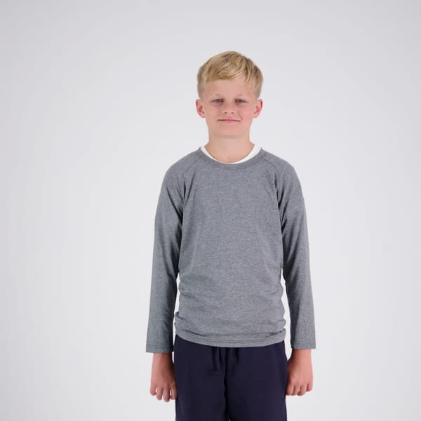 A grey long-sleeve t-shirt on a child stands against a plain background. The shirt has a logo.