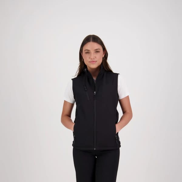 A black women's softshell vest with a zip front and pockets, worn over a white T-shirt.