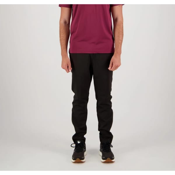 Black track pants on a model, paired with a maroon shirt and black shoes. The pants have a logo.