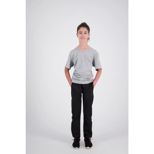 A child stands wearing grey trackpants and a plain grey t-shirt, showcasing a simple sports uniform look.