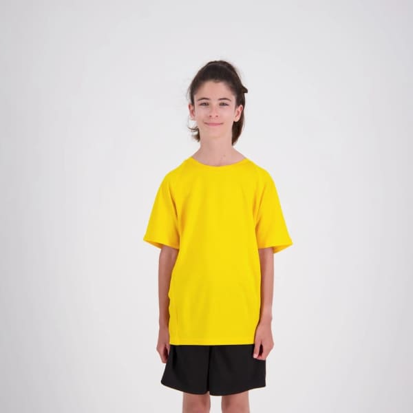 A bright yellow kids' performance t-shirt with a loose fit, paired with black shorts. Features a branding logo.