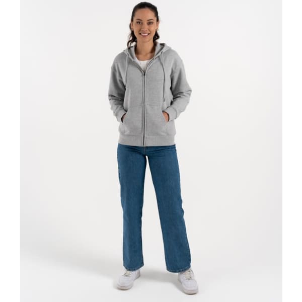 A grey zip hoodie featuring a hood, front pockets, and a relaxed fit, modelled by a woman.