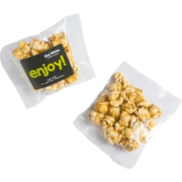 A bag of caramel popcorn featuring golden kernels in a clear wrapper with a logo.