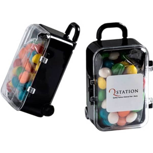 A small black carry-on case filled with colourful chewy fruit candies, featuring a clear lid and a logo.